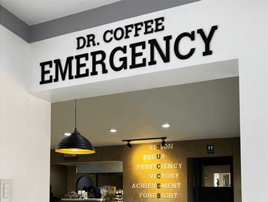 The EMERGENCY signage above the Dr. Coffee service counter